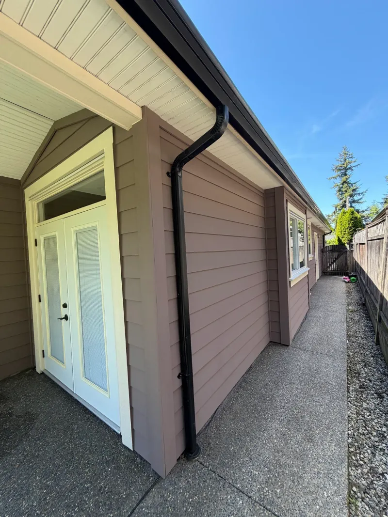 After: Side entry French doors and wall along a narrow walkway with downspout, Tsawwassen, Delta, BC