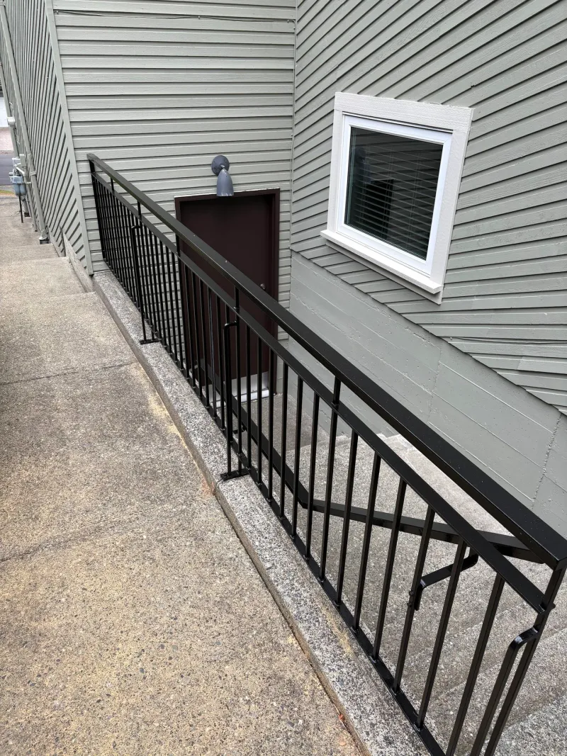 After: Side of house showing siding wall, window trim and metal stair railing, Tsawwassen, Delta, BC