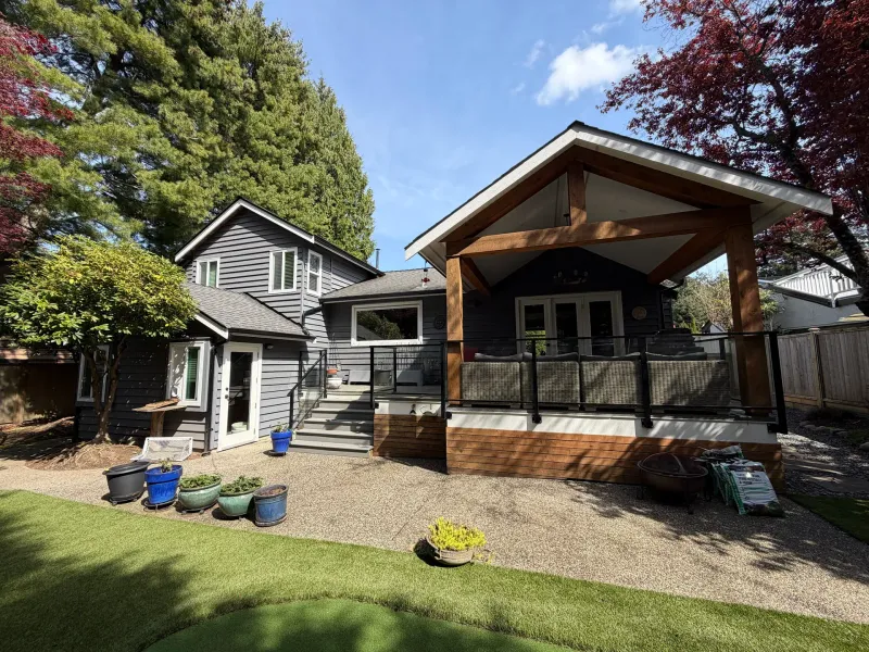 Before: Rear elevation of house with dark siding, covered deck and yard before painting, Tsawwassen, Delta, BC