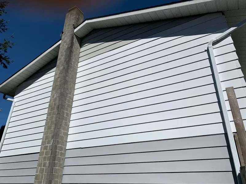 Before: Gable end of house with chimney and siding in two tones under blue sky, - Valley Cliff, Squamish, BC