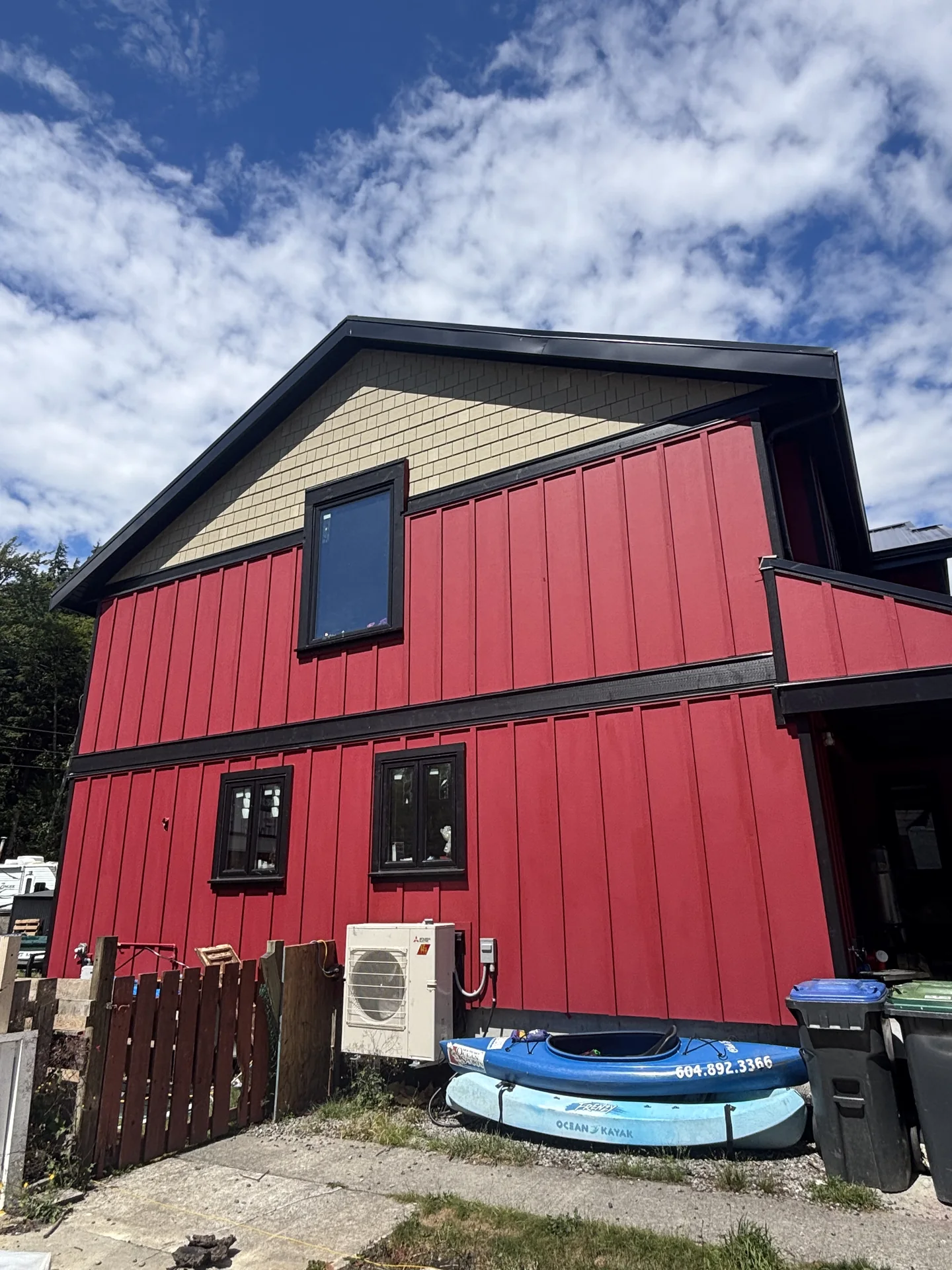 Completed exterior repaint with red siding and black trim in Valleycliffe, Squamish BC