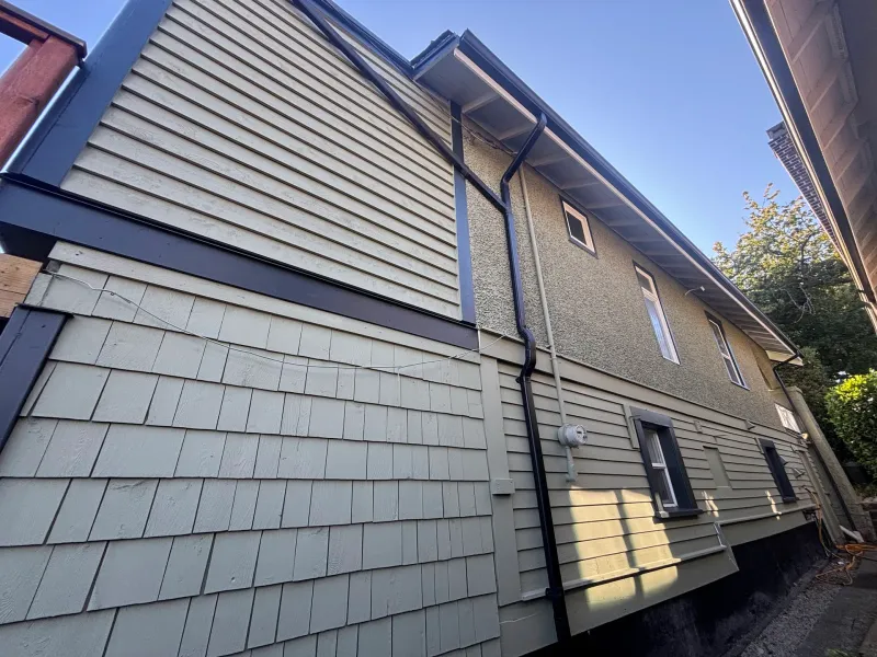 After: Side elevation showing gable end, shingled wall, gutter downspout and windows, Vancouver, West Vancouver, BC