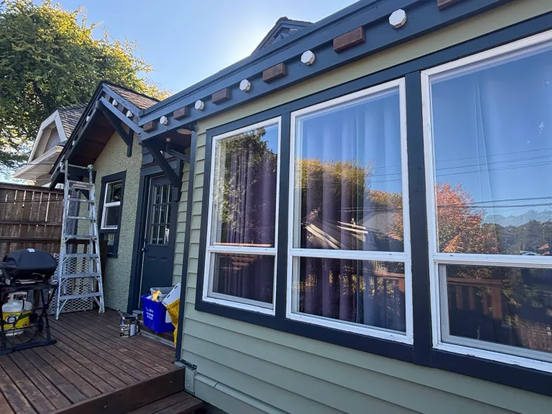 After: Side elevation with multiple windows, trim, deck, and adjoining gable roofline, Vancouver, West Vancouver, BC