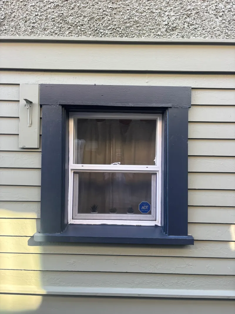 After: Close view of a window with painted trim surround, Vancouver, West Vancouver, BC