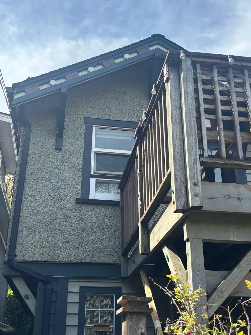 Before: Side elevation showing upper window, wall surface, and deck railing corner, Vancouver, West Vancouver, BC