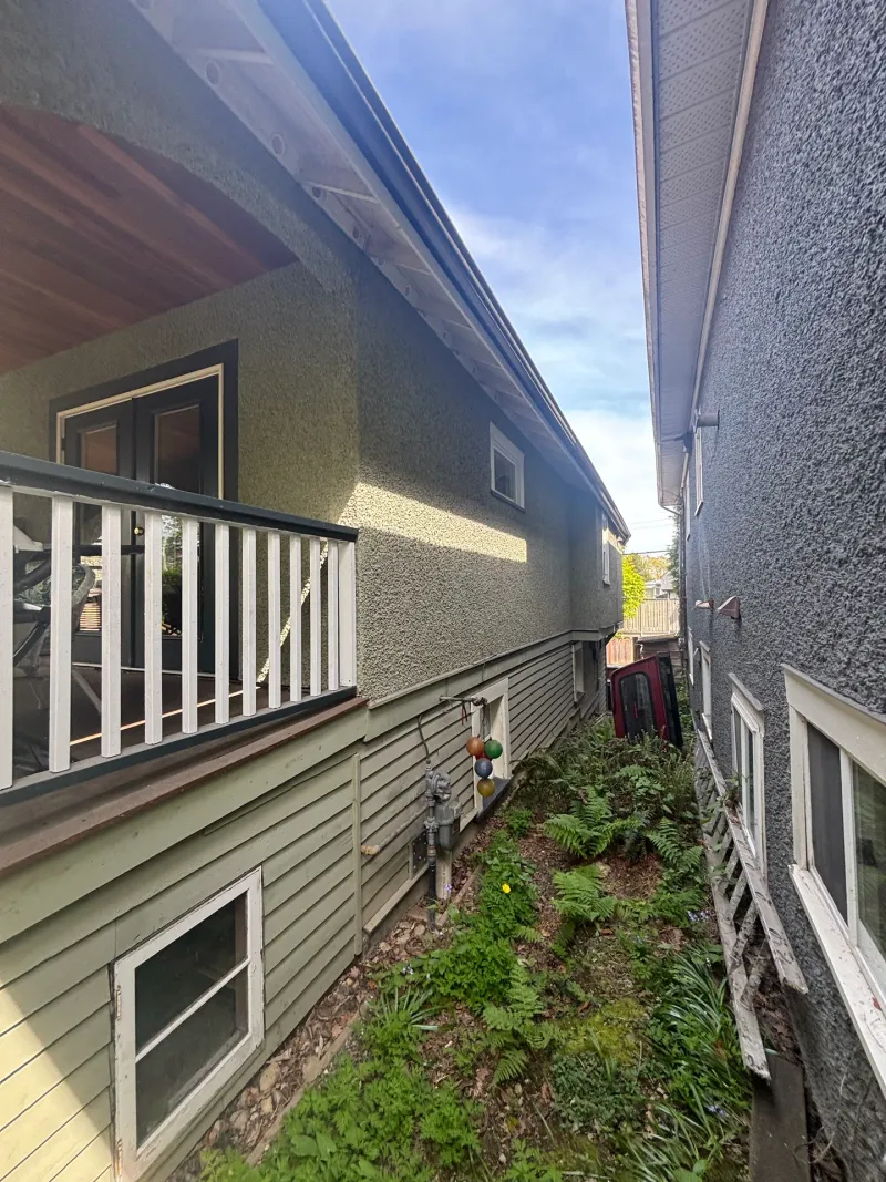 Before: Side elevation with upper deck, door, and narrow side yard passage, Vancouver, West Vancouver, BC