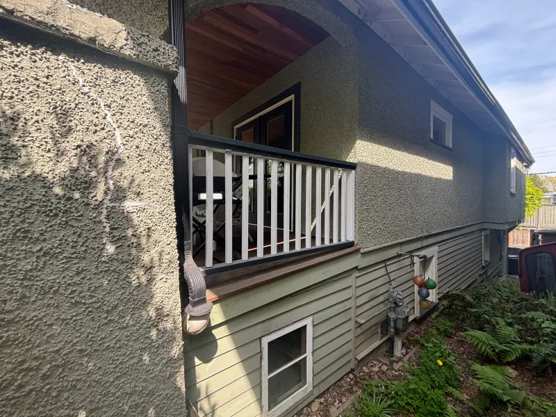 Before: Side elevation showing arched overhang, deck railing, and lower siding, Vancouver, West Vancouver, BC