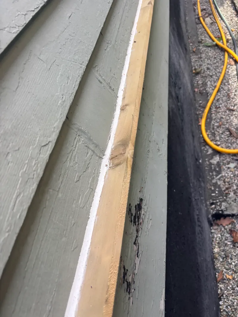 Before: Close detail of a new trim board against siding, Vancouver, West Vancouver, BC