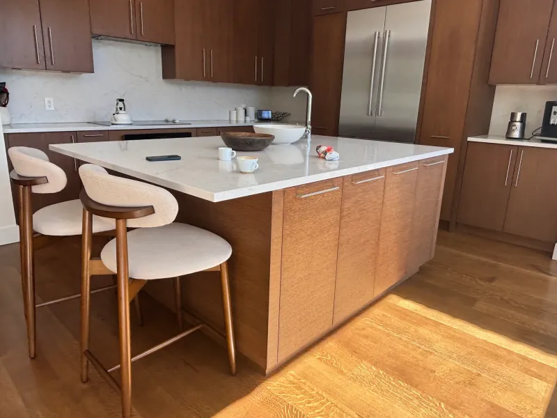 Before: Kitchen island with countertop seating and cabinets along the back wall, Whistler, BC