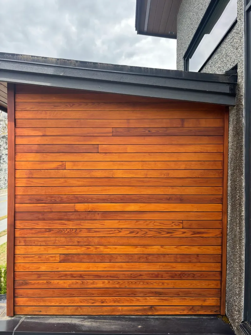 After: Refinished garage door under a flat roof overhang, Whistler, BC