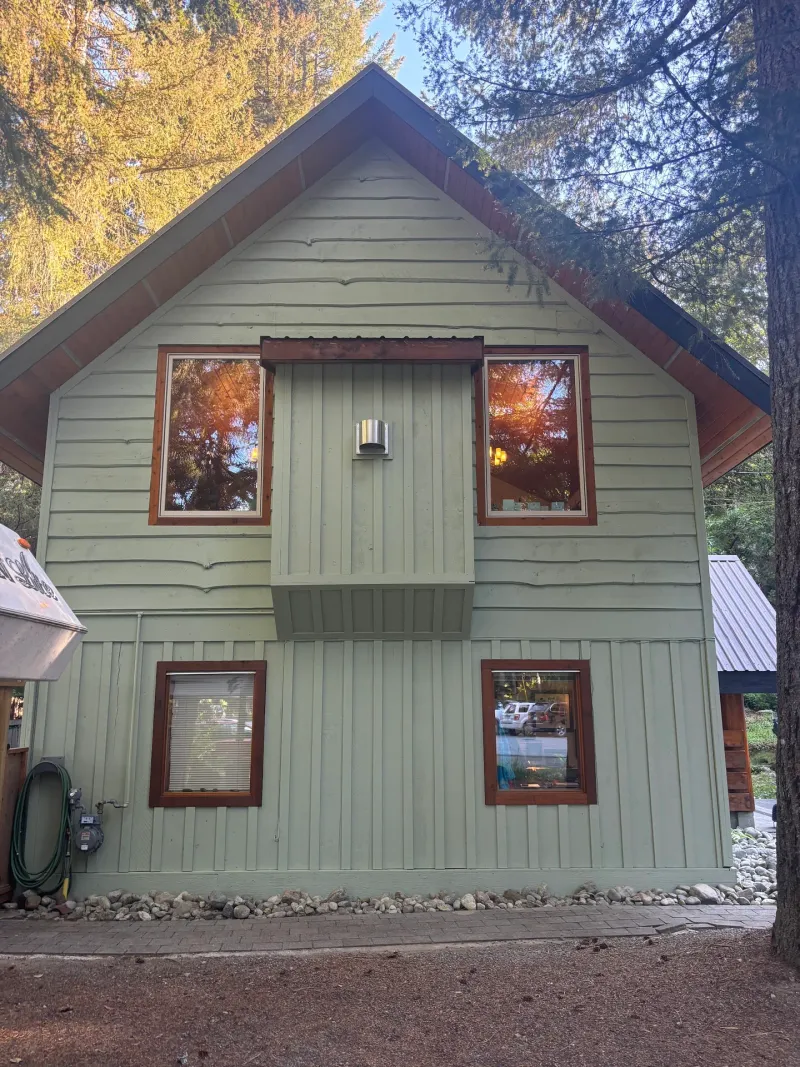 After: Gable end elevation with upper windows and vertical siding after painting, Whistler, BC