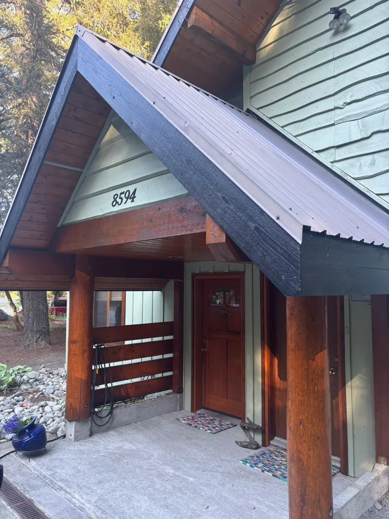 After: Front covered entry with door and posts after painting, Whistler, BC