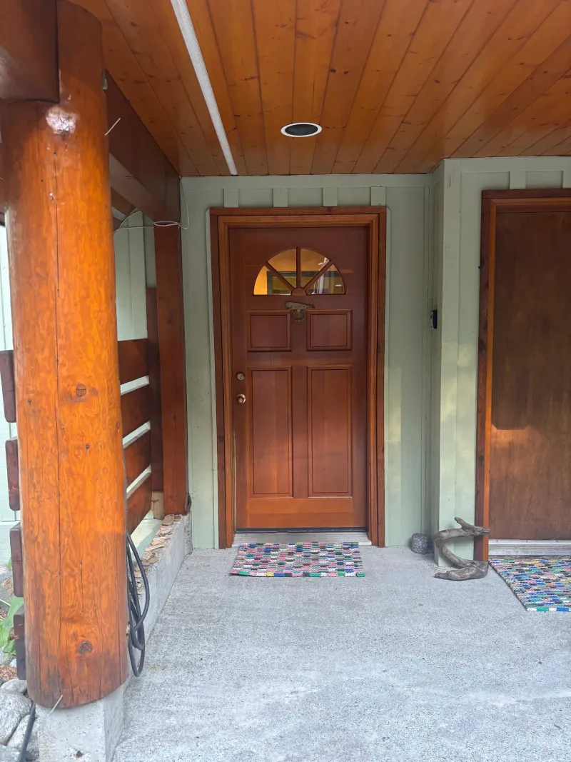 After: Close-up of front door and covered porch ceiling after painting, Whistler, BC