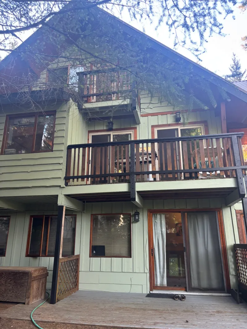 After: Rear elevation with balcony, sliding door, and windows after painting, Whistler, BC