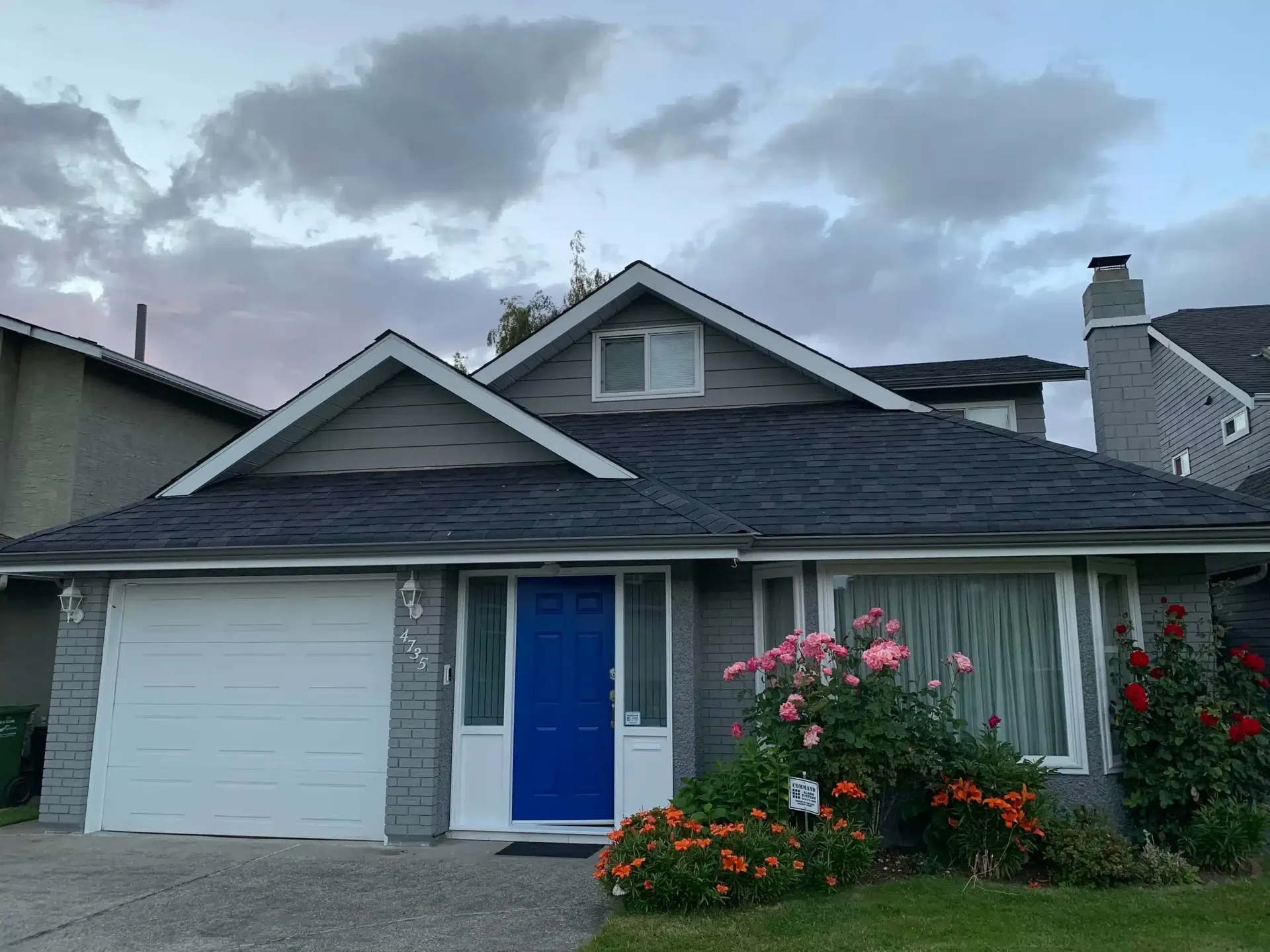Single-story home with light siding and blue front door