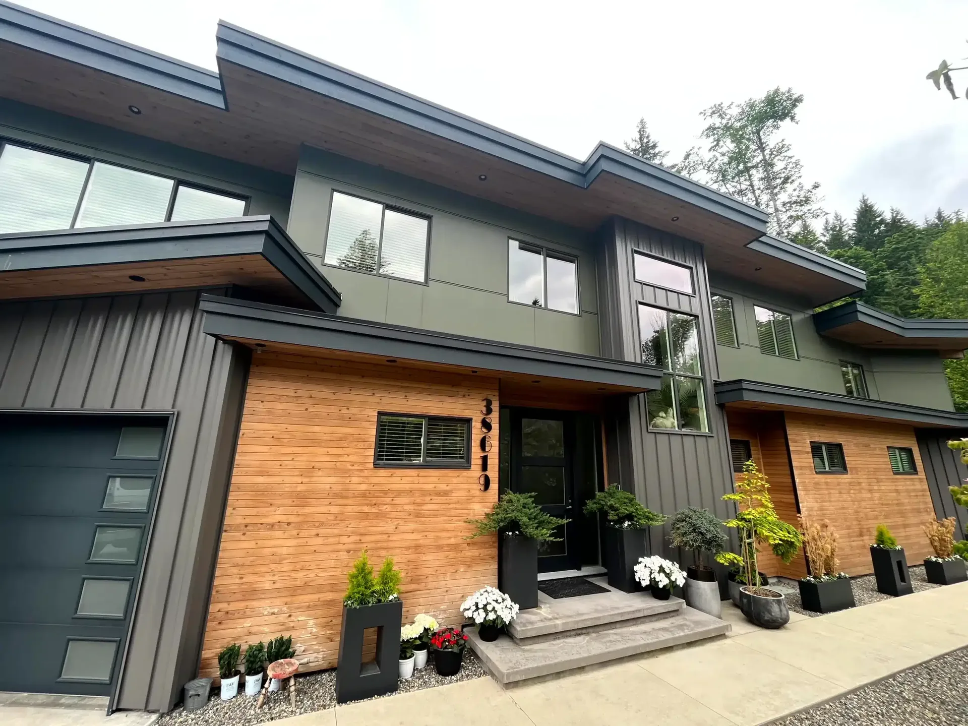 Modern home exterior with mixed wood and dark grey siding