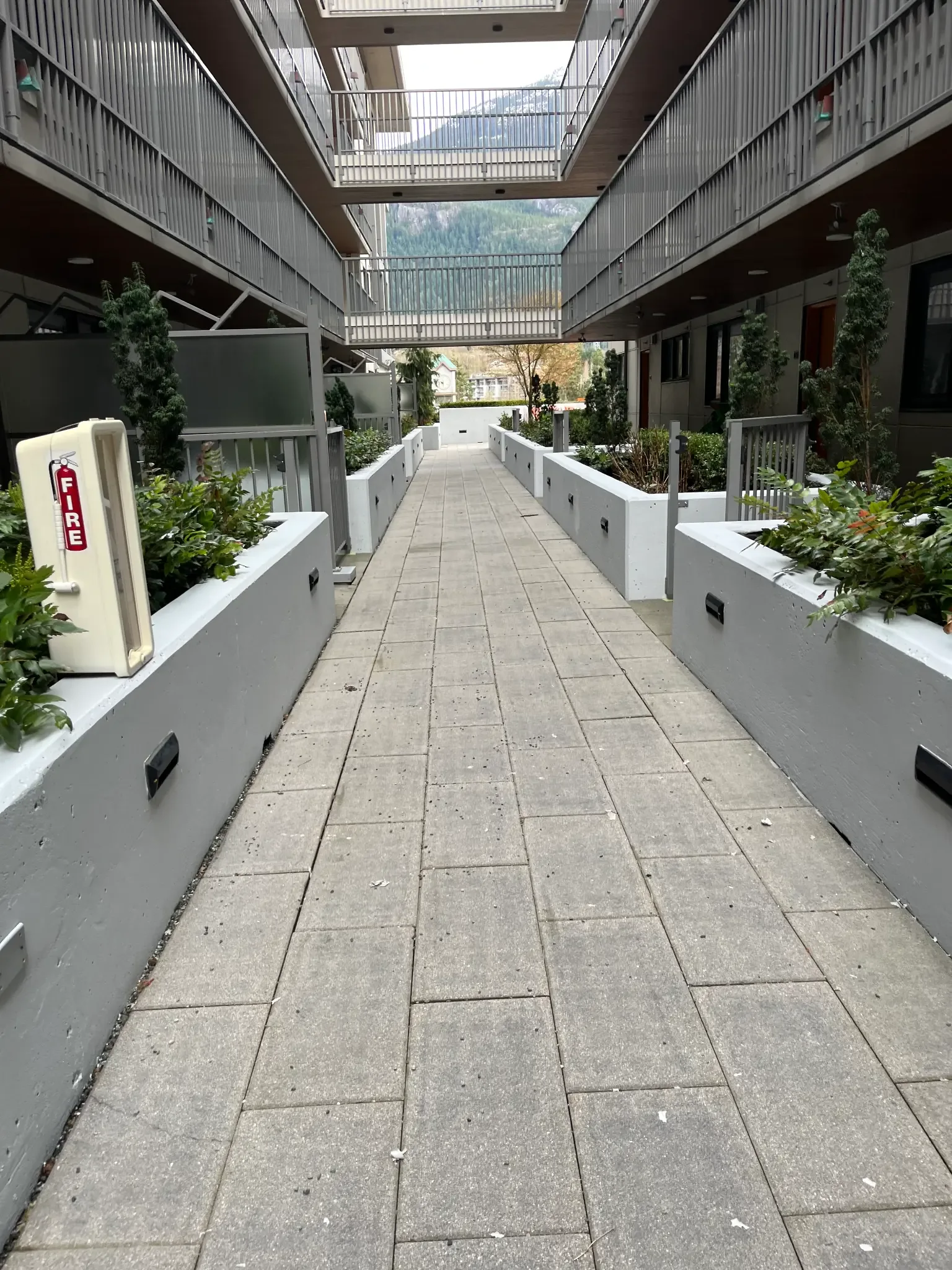 Avesta Property Management courtyard retaining wall restoration — Downtown Squamish BC by Colour Craft Painting