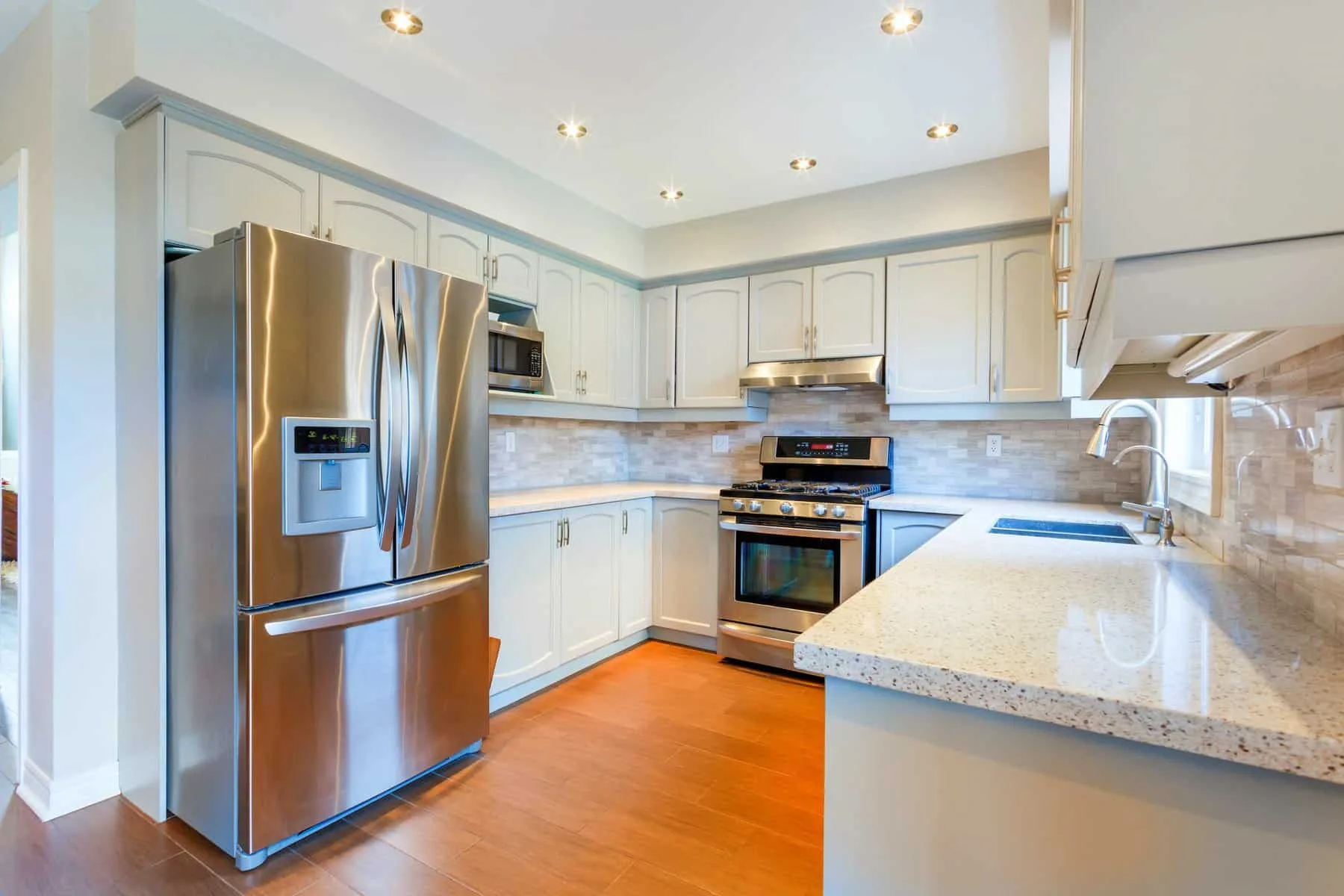 Light grey painted cabinets with stainless steel appliances