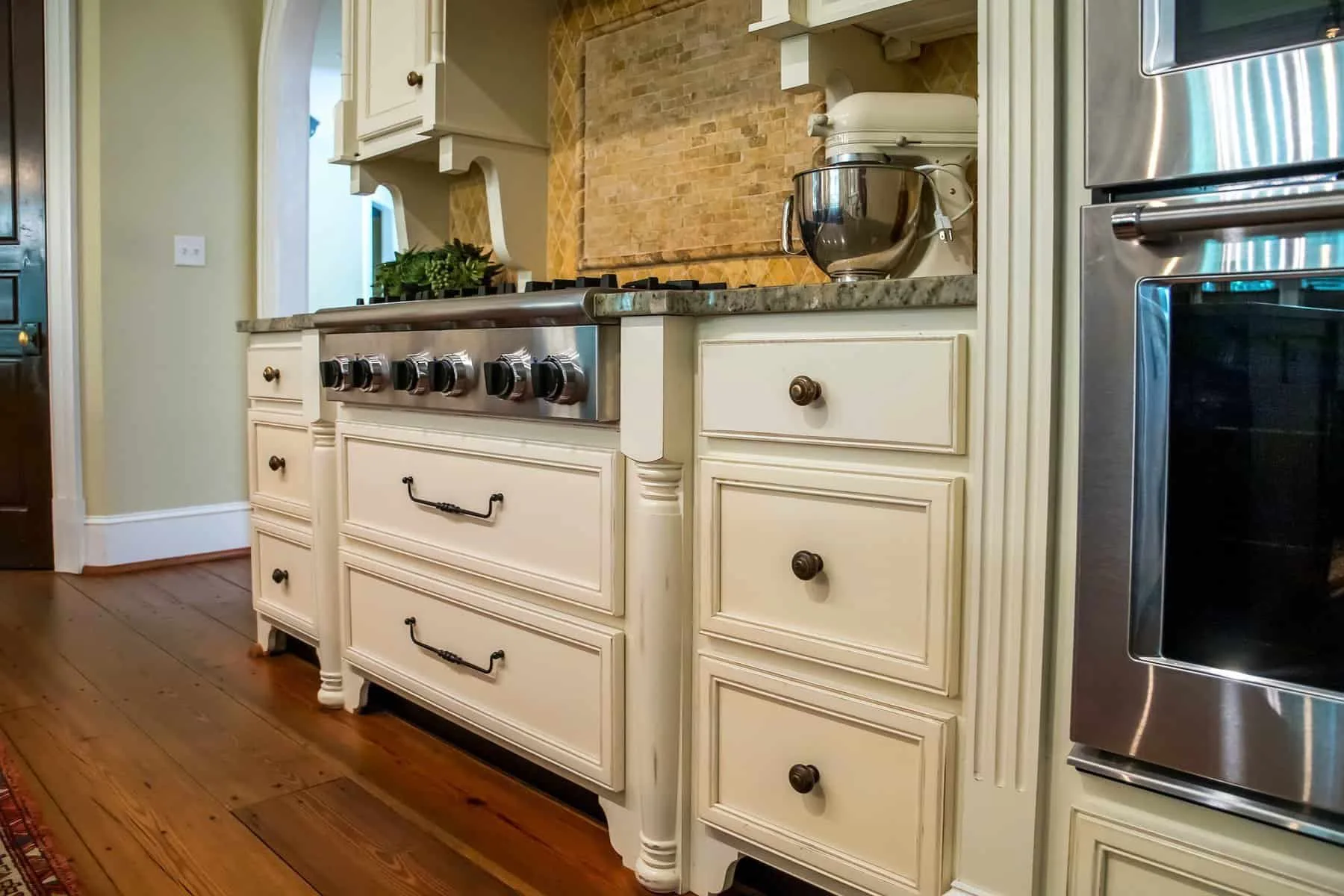Cream colored painted cabinets with granite countertops