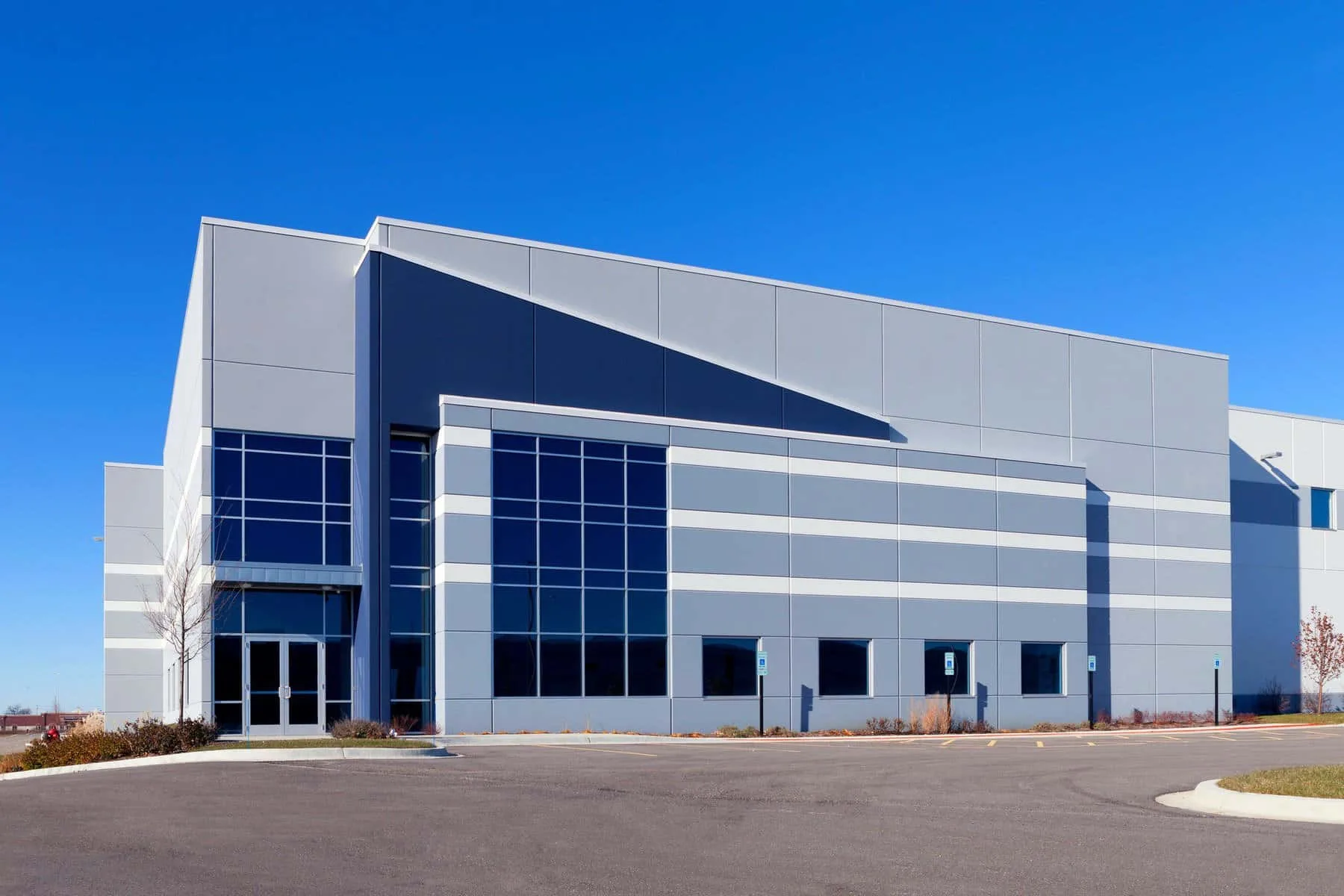 Large modern industrial building exterior painting — Colour Craft Painting