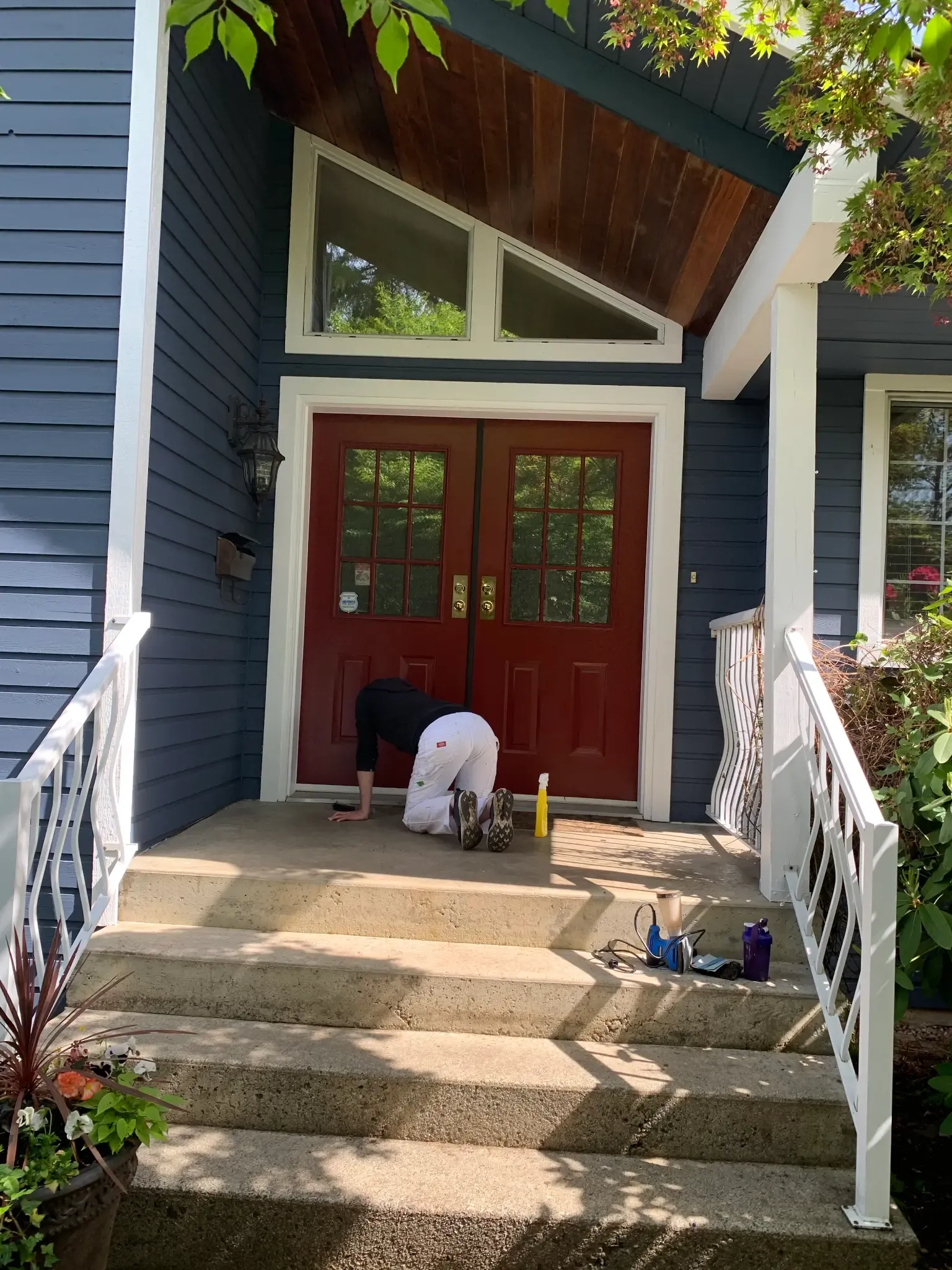 After — Painter doing final detail work at front door, Brackendale Squamish BC
