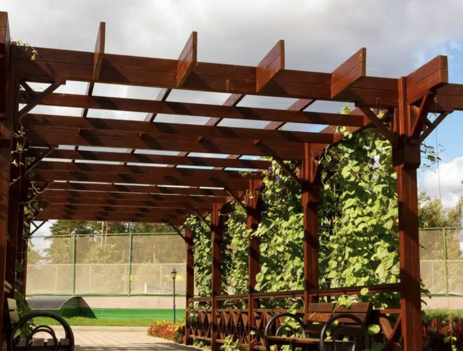 Beautifully stained wood arbour/pergola with climbing vines — outdoor structure painting by Colour Craft Painting
