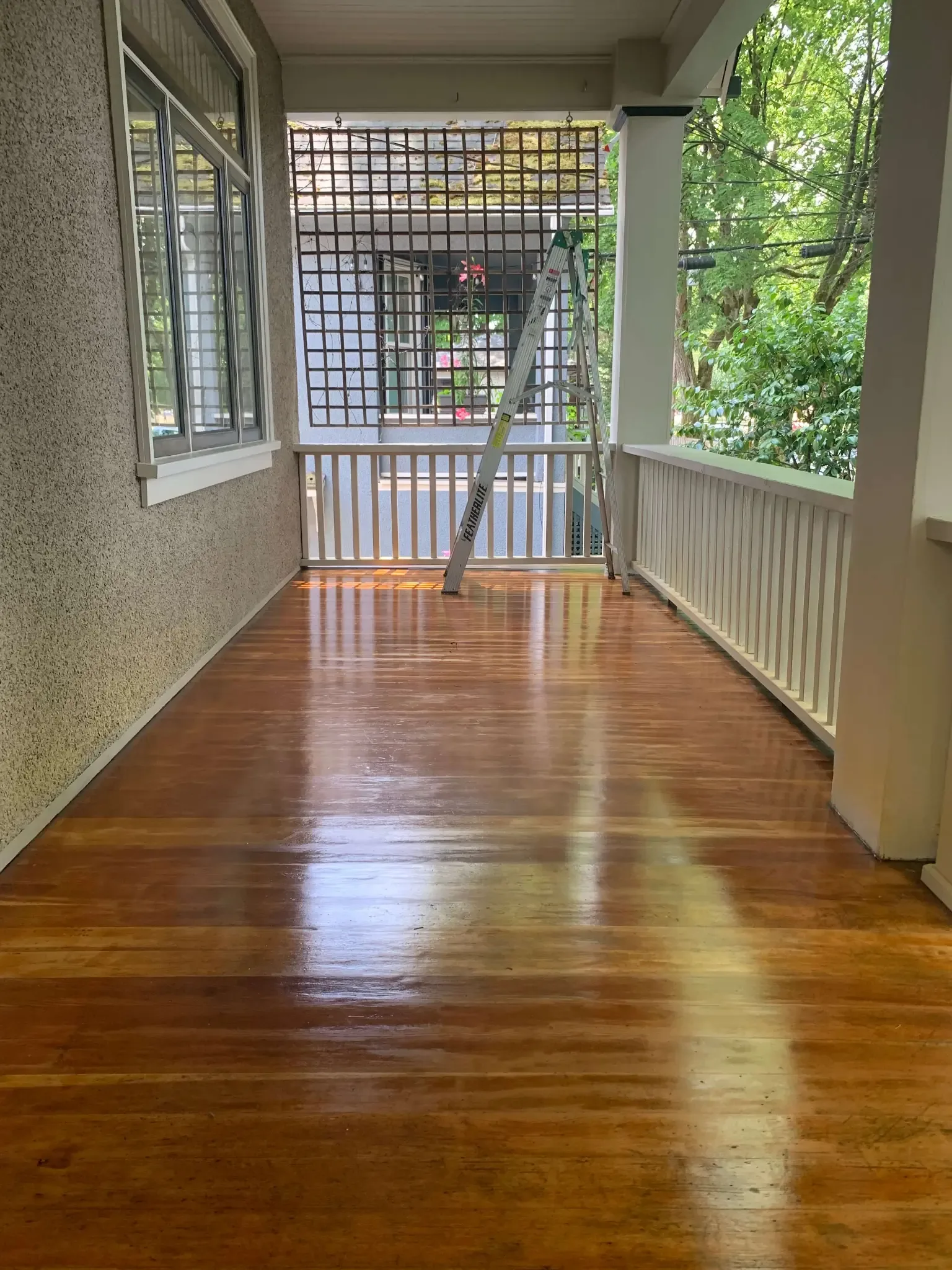 After deck staining — gleaming freshly stained porch floor by Colour Craft Painting
