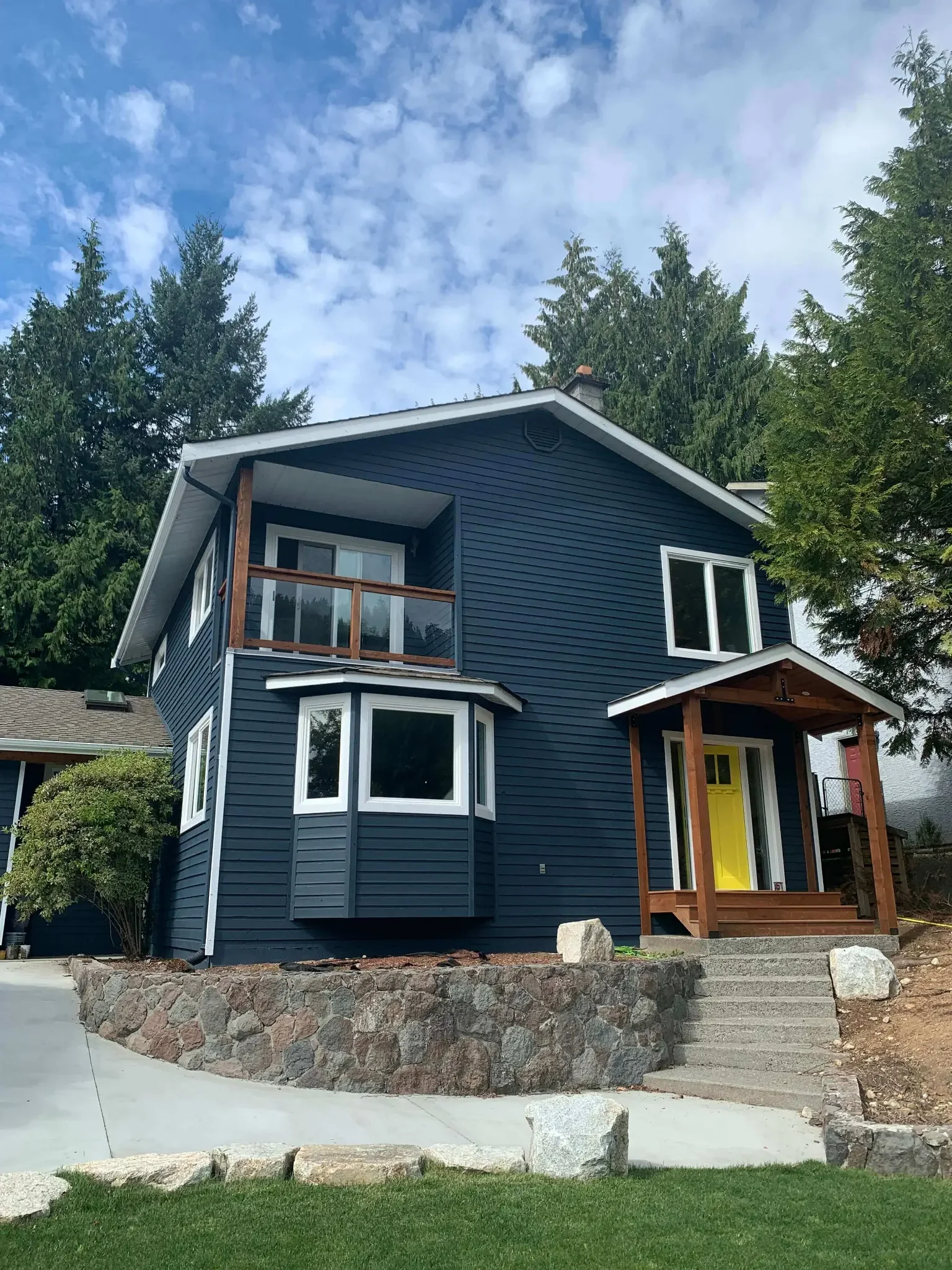 Exterior painting in progress — navy siding Squamish BC, Colour Craft Painting