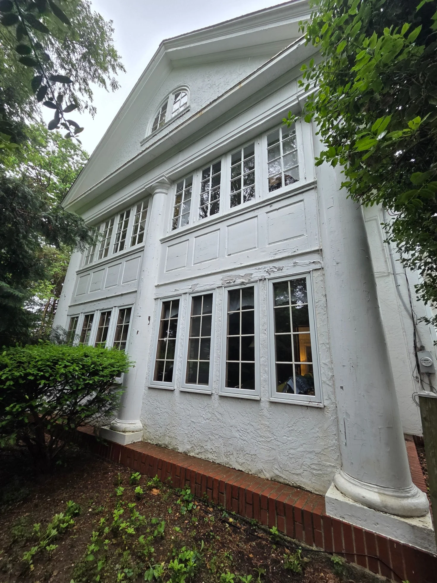 Peeling exterior paint on Philadelphia area home before repainting - freeze-thaw damage to trim and columns