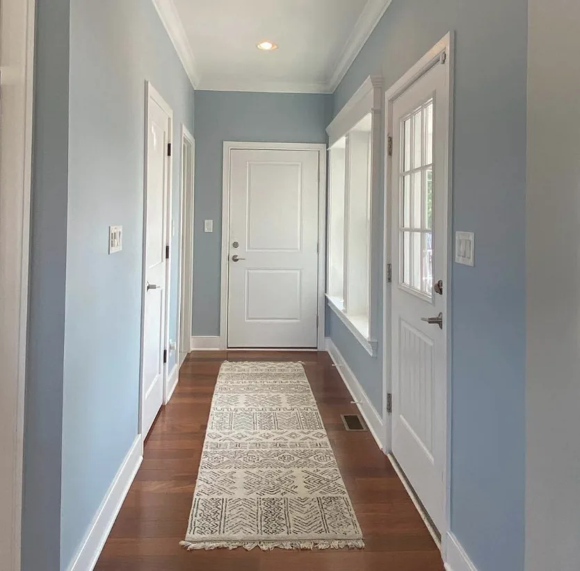 Wall painting — blue hallway with white trim and hardwood floors by Colour Craft Painting