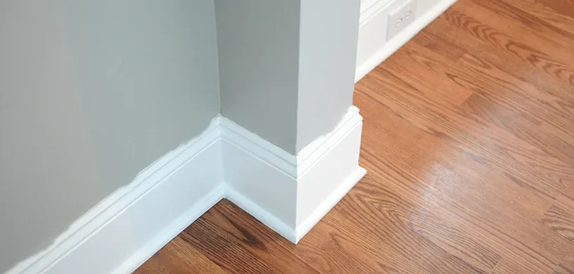 Trim painting — crisp white baseboards against blue wall by Colour Craft Painting