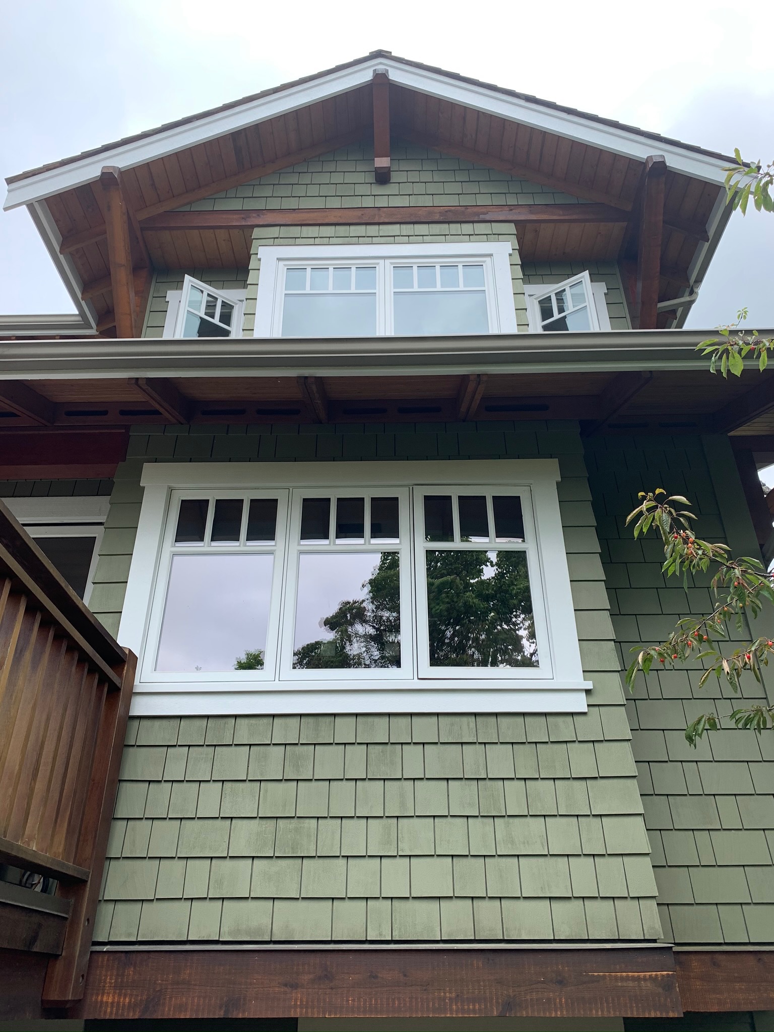 Completed green siding and natural wood framing at James’s North Vancouver home