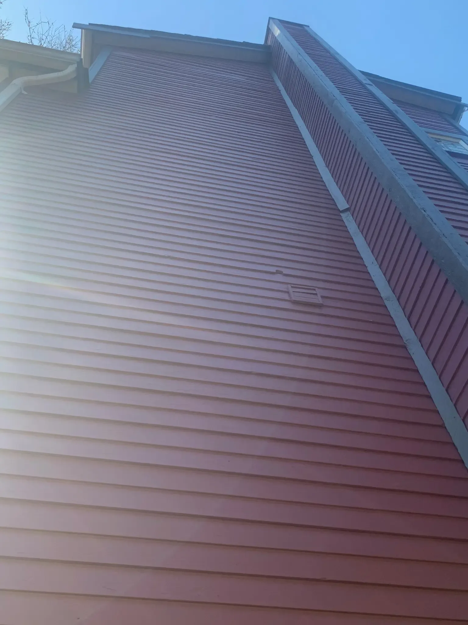 After — Purple siding with charcoal trim detail, East Vancouver