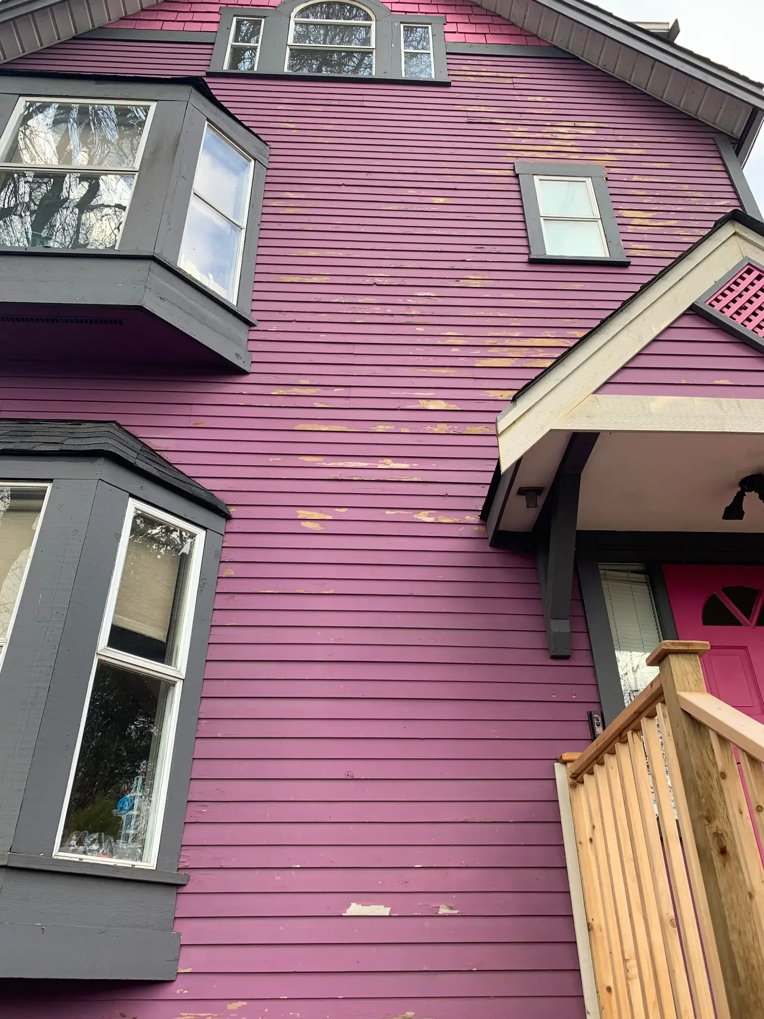 Before — Lower front view showing extent of siding failure, East Vancouver
