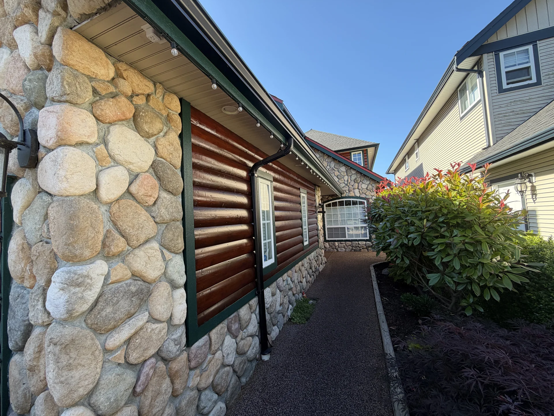 After front-side view of refreshed log siding on Larry’s Steveston home