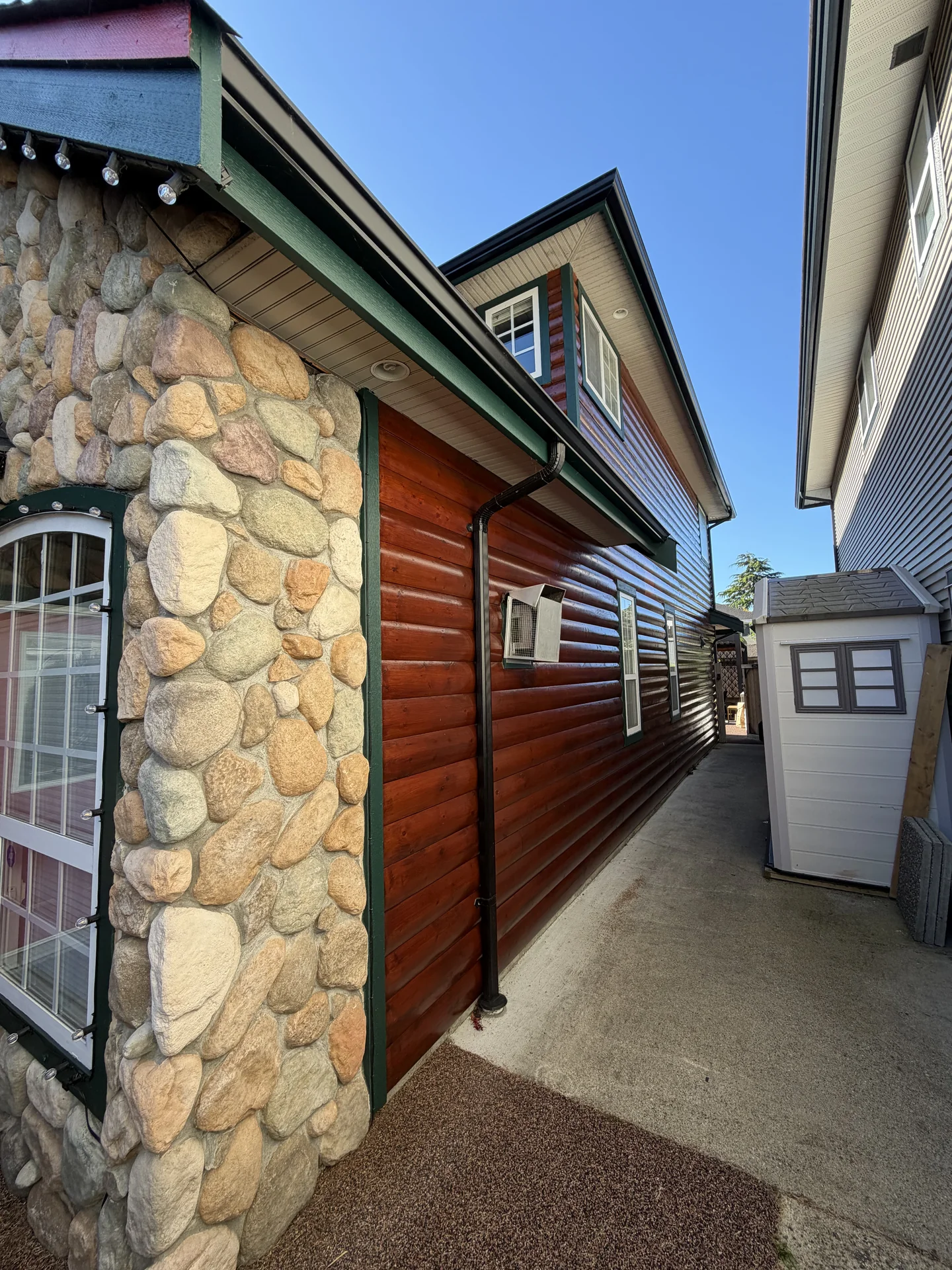 Completed exterior view of refreshed log siding in Steveston Richmond BC