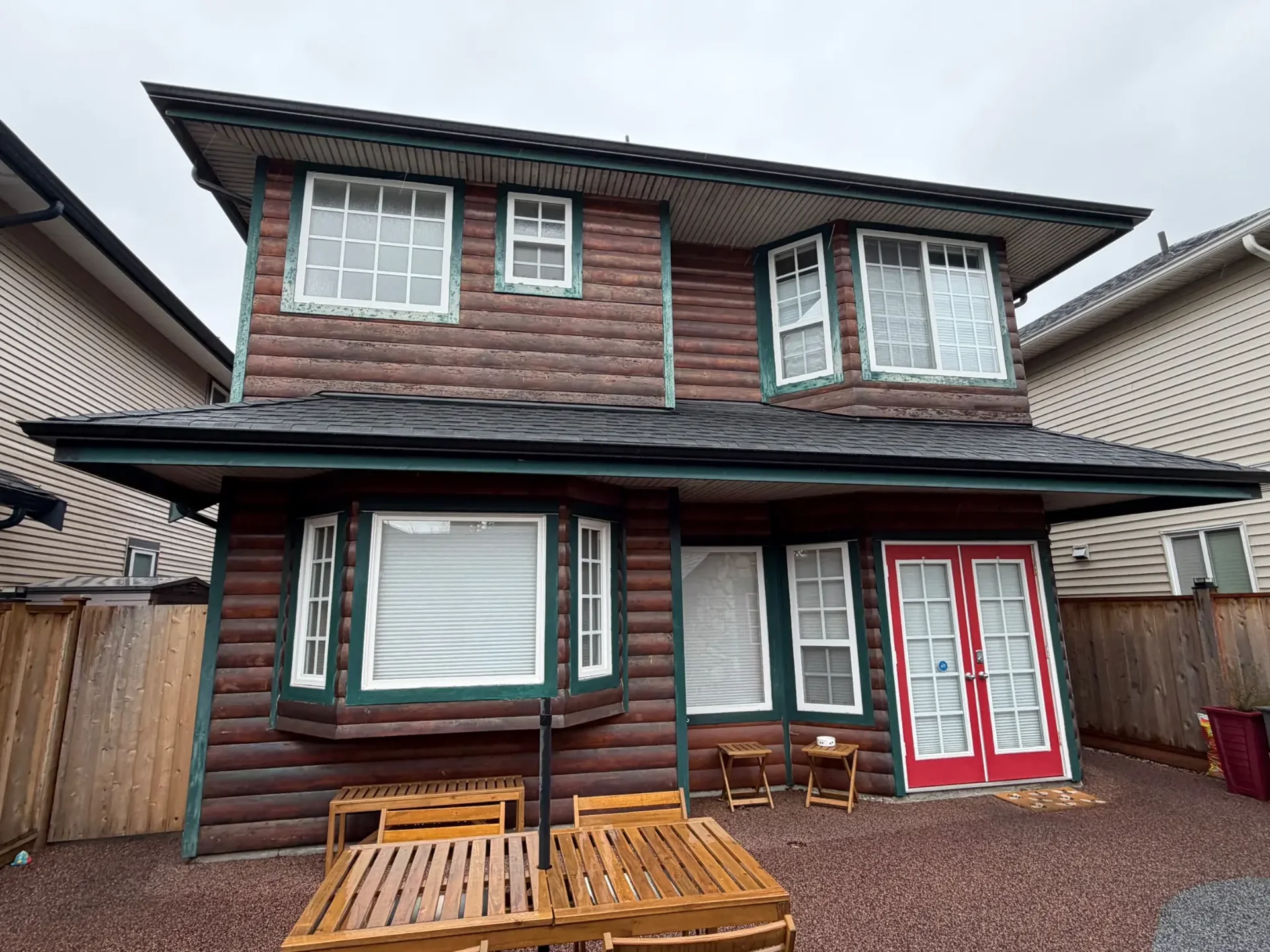 Before front exterior view of log siding and stone facade in Steveston Richmond BC