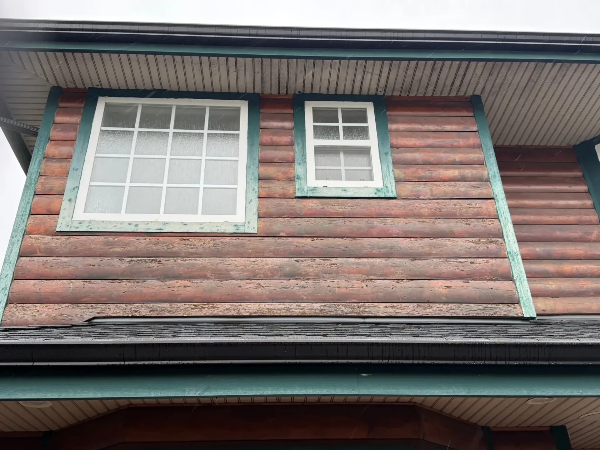 Before upper exterior detail of weathered log siding and trim in Steveston Richmond BC