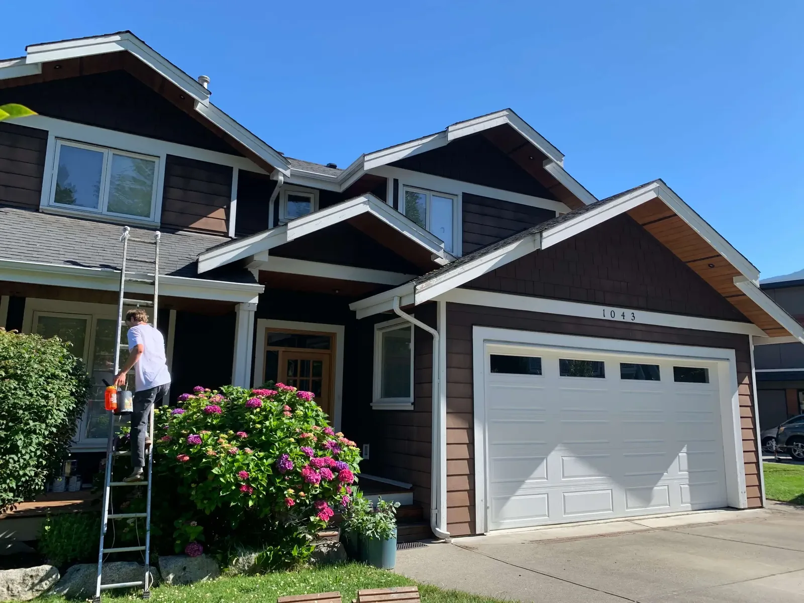 Before — Matt residence exterior painting, Garibaldi Highlands Squamish BC — Colour Craft crew on ladder