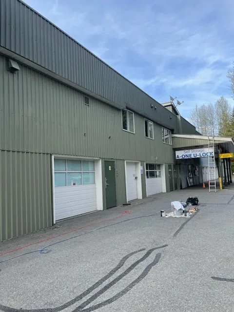 Commercial painting Squamish BC — warehouse exterior with boom lift