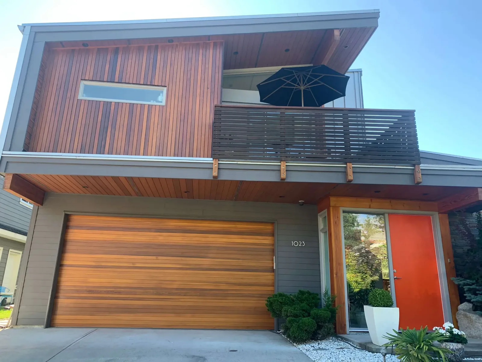 After — Cedar wood restoration back view, warm amber Sikkens stain, Squamish BC