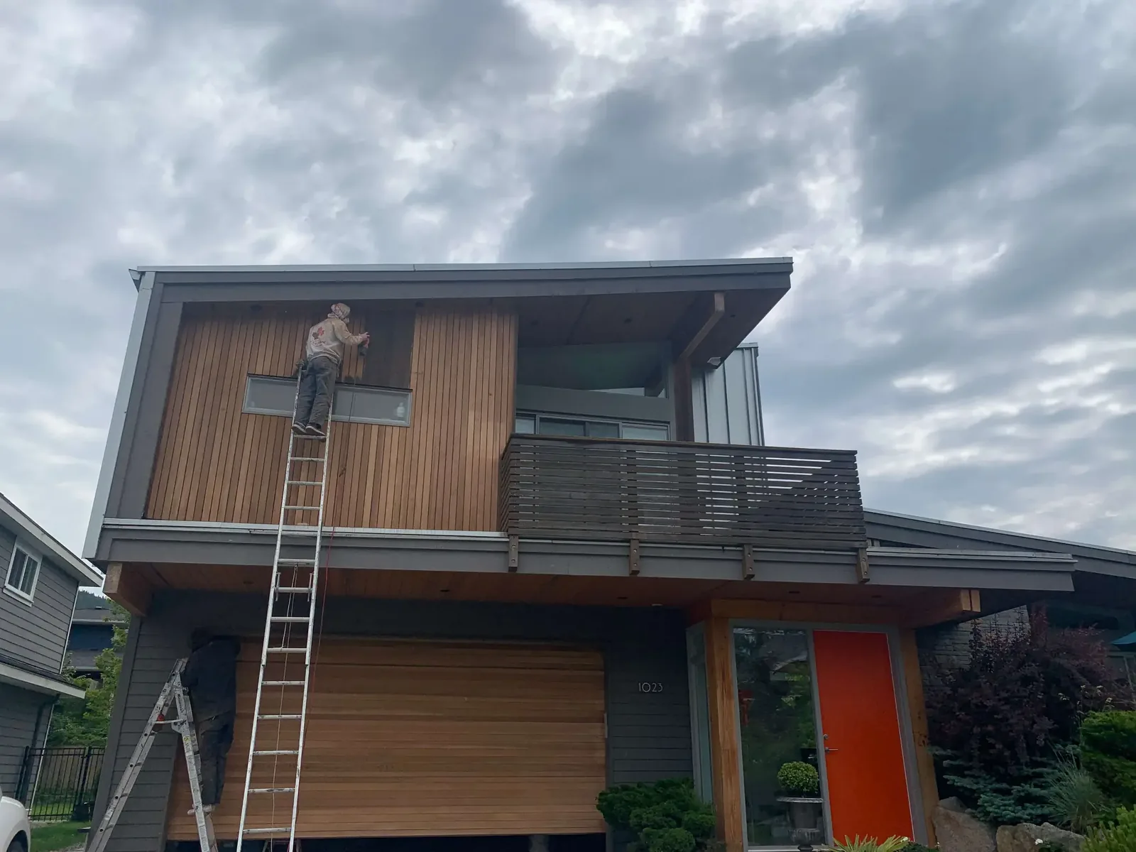 Before — Colour Craft crew applying Sikkens stain to cedar, Squamish BC