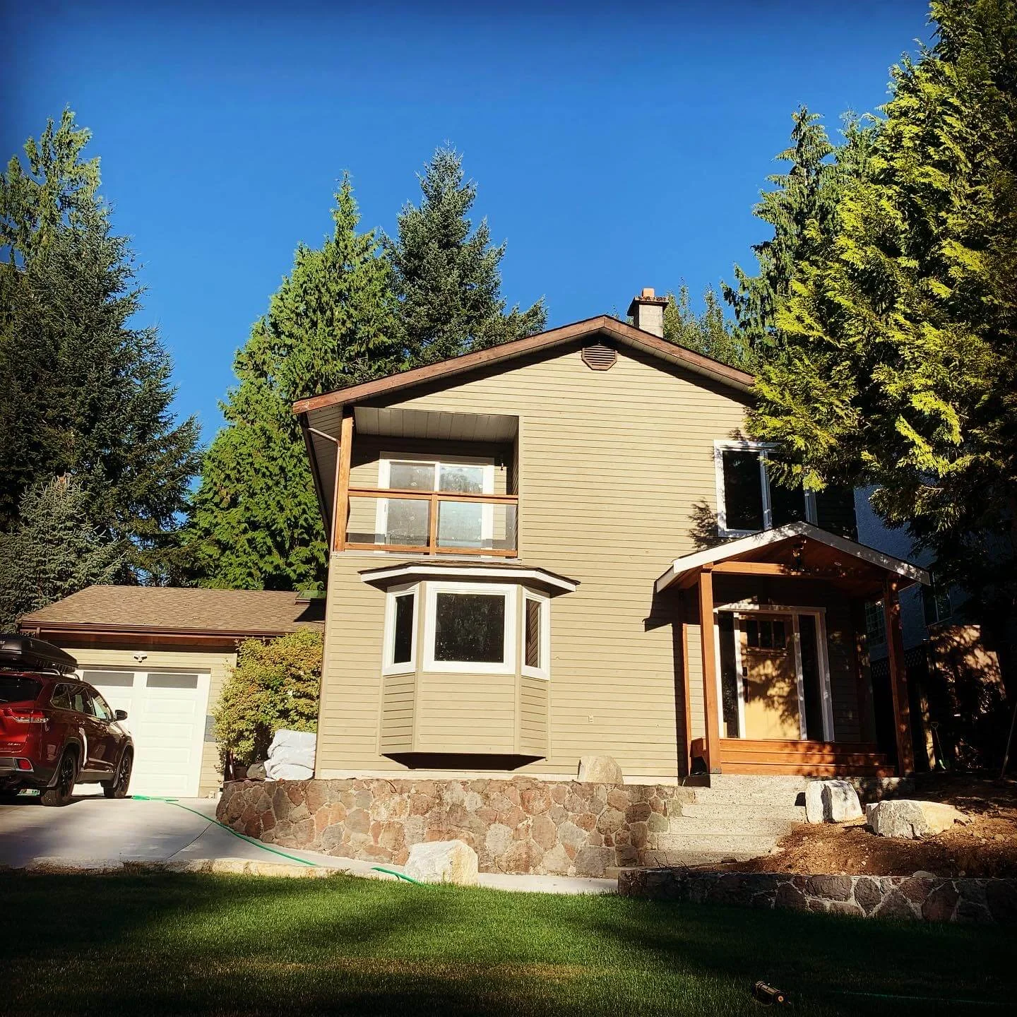 Yellow front door painting with cedar porch — exterior painting Squamish BC by Colour Craft Painting