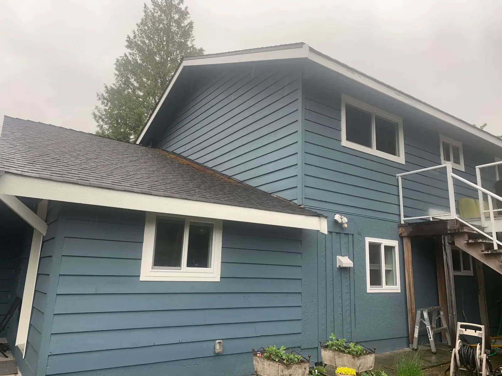 After — Yves residence back view, completed steel blue siding, Garibaldi Highlands Squamish BC