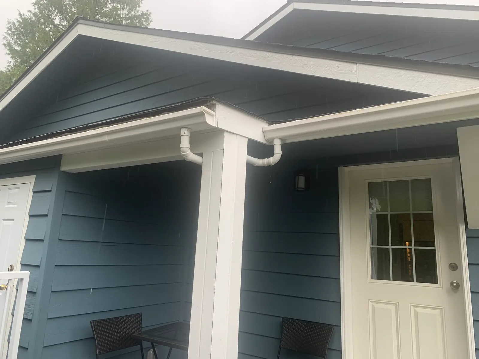 After — Yves residence porch detail, white trim and blue siding, Garibaldi Highlands Squamish